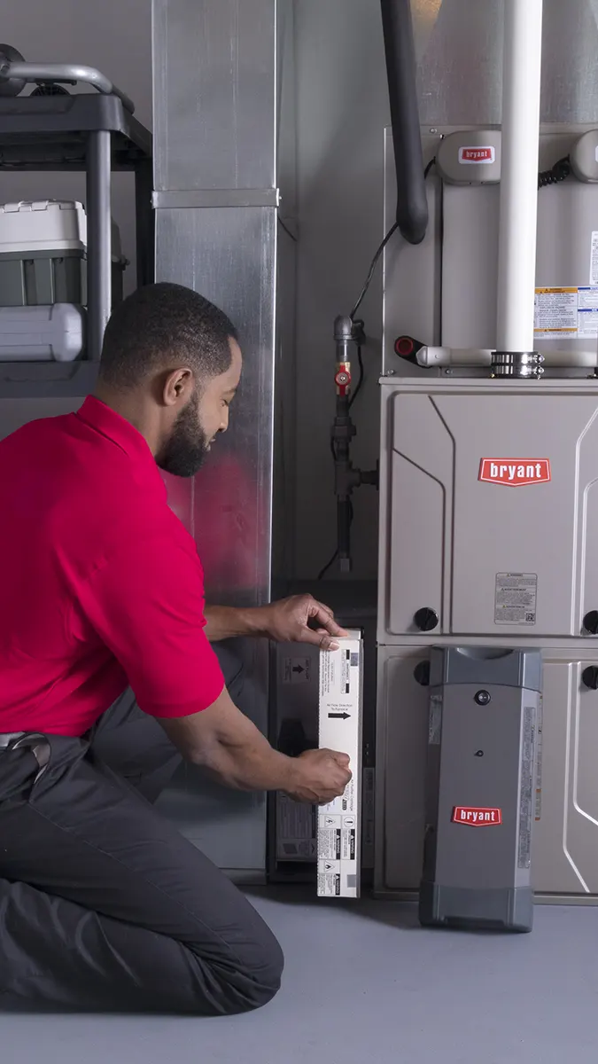 Furnace Repair Technician working in homeowner's basement from behind | Furnace Repair | White Sands Cooling and Heating