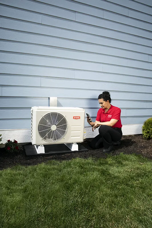 HVAC Technician servicing a mini split AC outside customer's home | White Sands Cooling and Heating