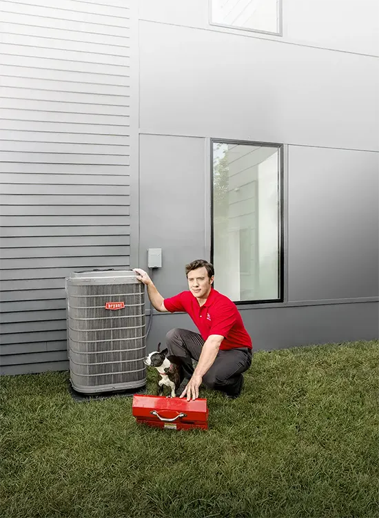HVAC repairman kneeling down beside a outdoor AC Unit with toolbox | White Sands Cooling & Heating