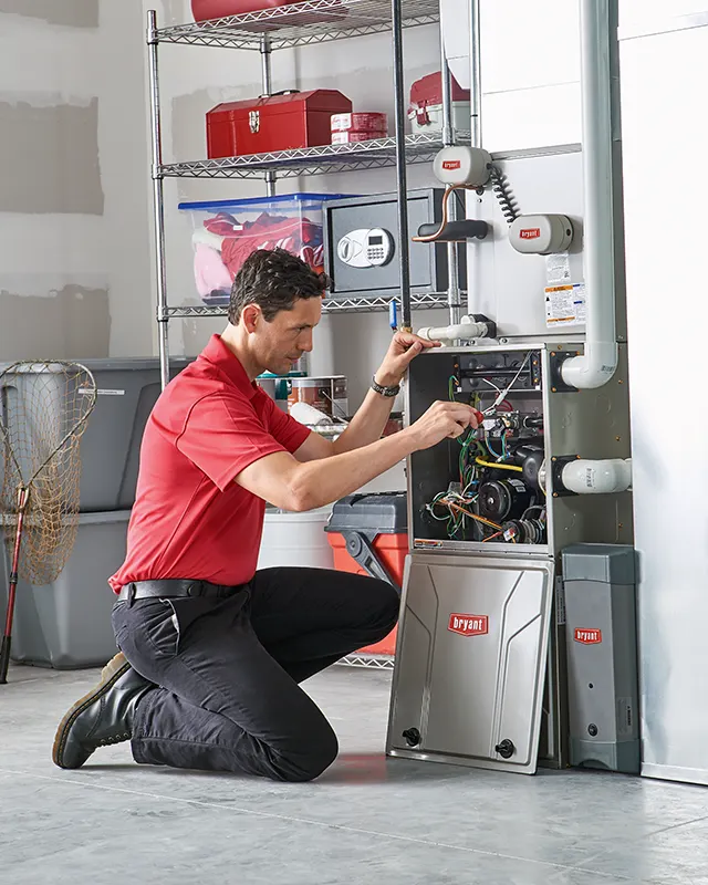 Technician working on a furnace | White Sands Cooling and Heating