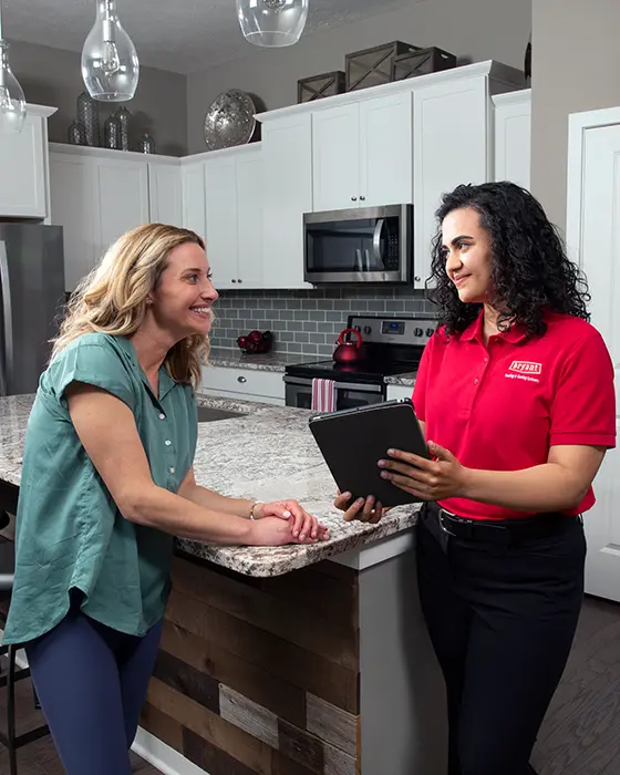 Customer discussing HVAC financing options with a female HVAC technician | White Sands Cooling and Heating